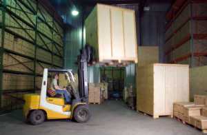 Man working on the forklift truck in the warehouse